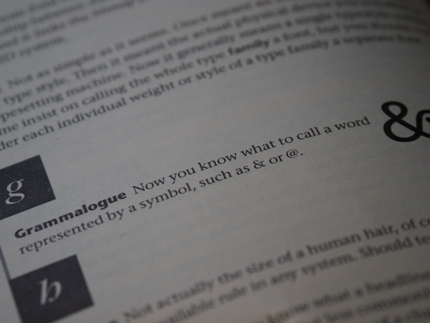 A close-up view of a page from an instructional text, focused on a section with the word 'Grammalogue' in bold, followed by a sentence explaining the term. The background shows blurred text with variations in typography size and boldness.