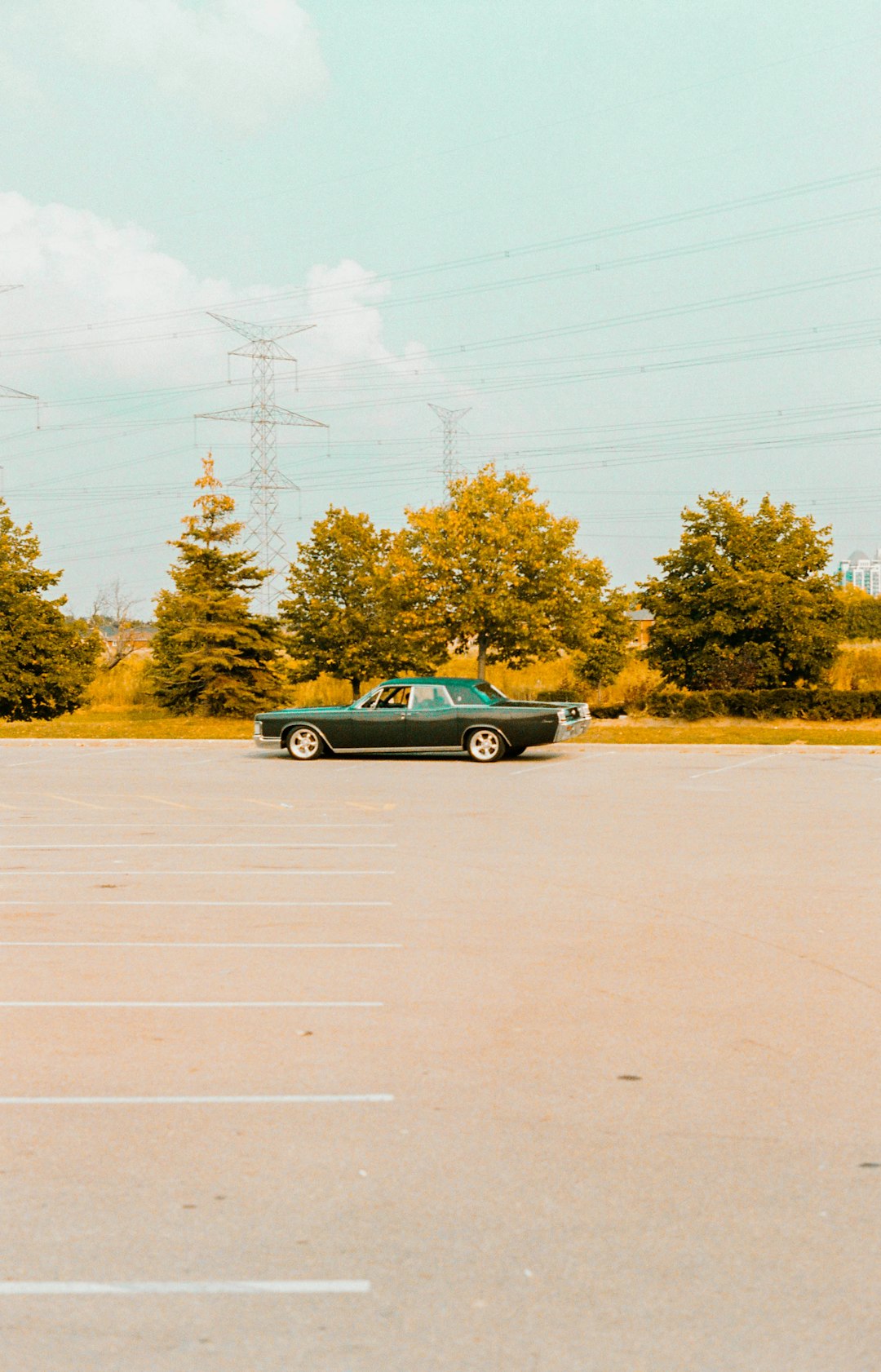 black coupe parked on gray concrete road during daytime