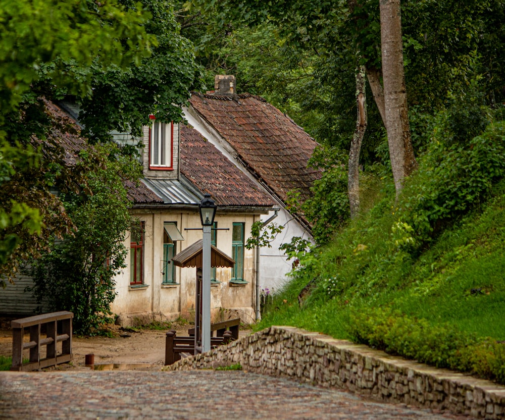 white and brown house near green trees during daytime