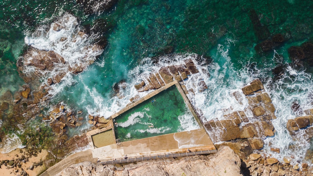 aerial view of brown concrete stairs on body of water during daytime