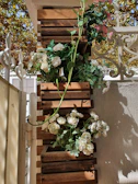 Vertical planters filled with vibrant flowers hanging on a wooden fence in a cozy garden.