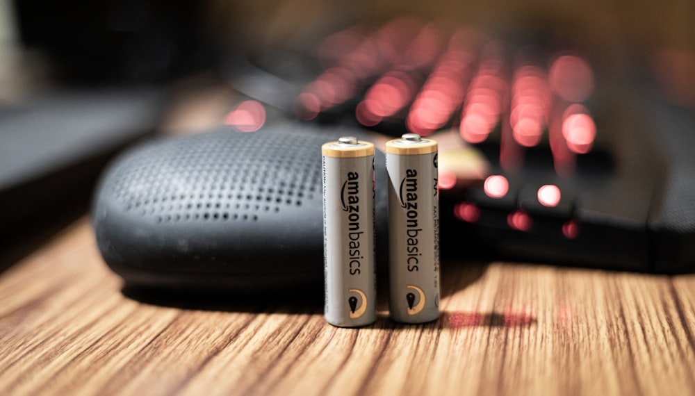 gray and gold battery on brown wooden table