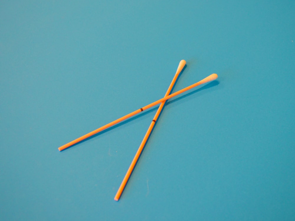 brown wooden sticks on blue surface