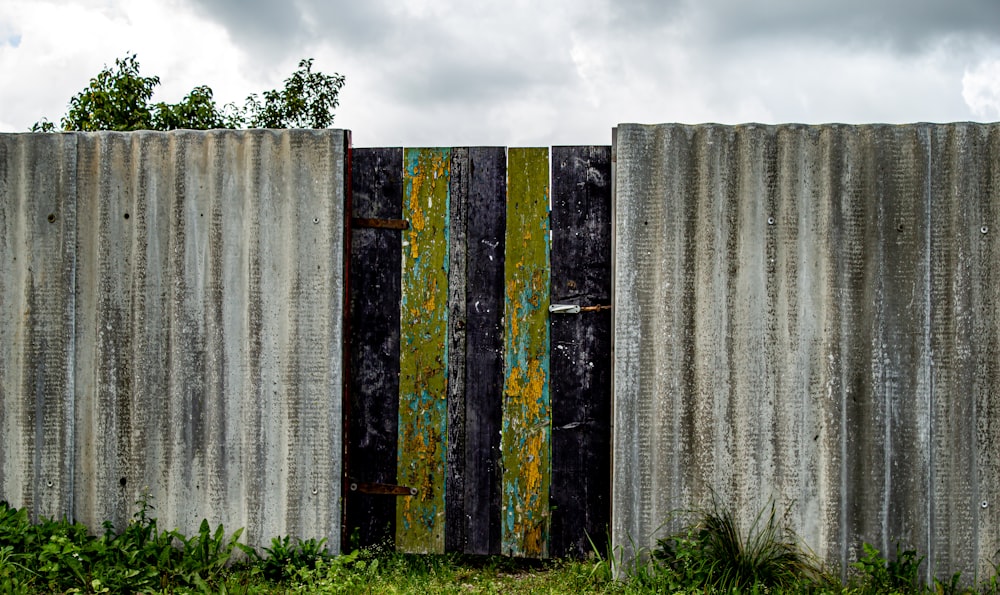 gray wooden fence on green grass field