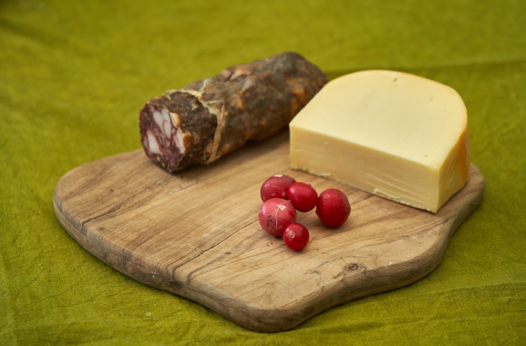 red round fruits on brown wooden chopping board