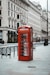 red telephone booth near white concrete building during daytime