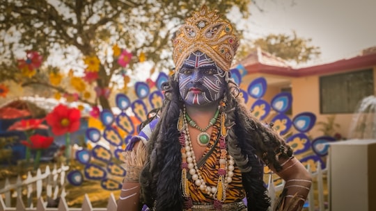 person wearing yellow and green mask in Surajkund India