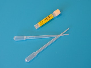 white ballpoint pen beside yellow and white plastic tool