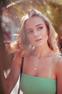 woman in green spaghetti strap top