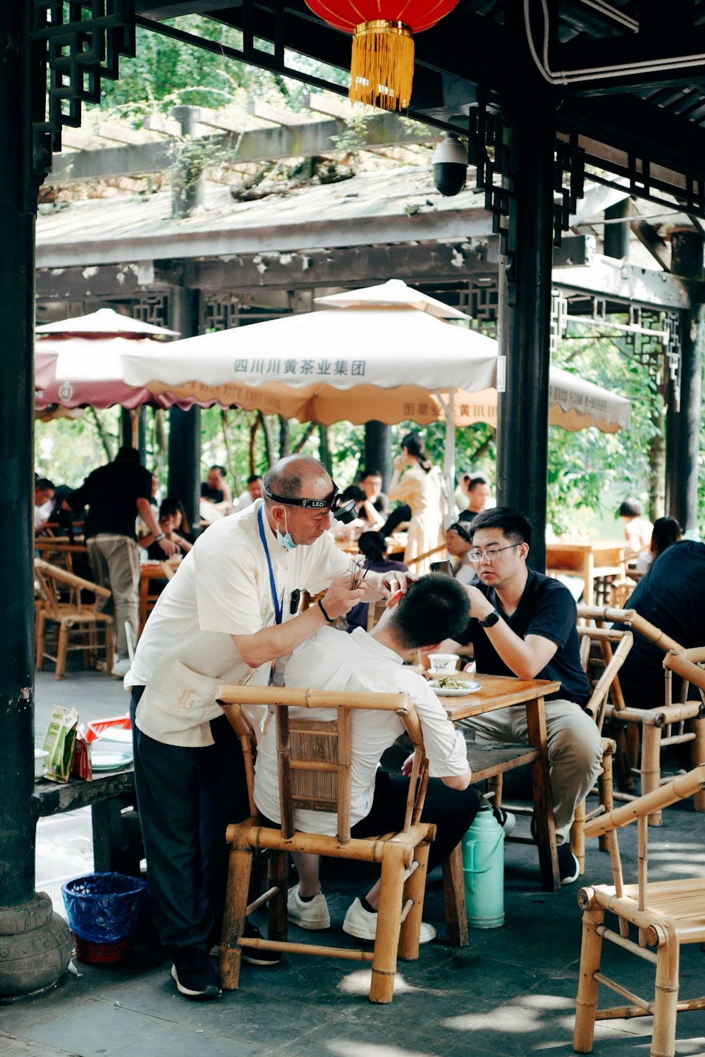 people sitting on brown wooden chairs during daytime