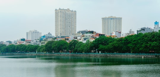 city skyline near body of water during daytime in West Lake Vietnam