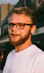man in white crew neck shirt wearing black framed eyeglasses