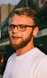 man in white crew neck shirt wearing black framed eyeglasses
