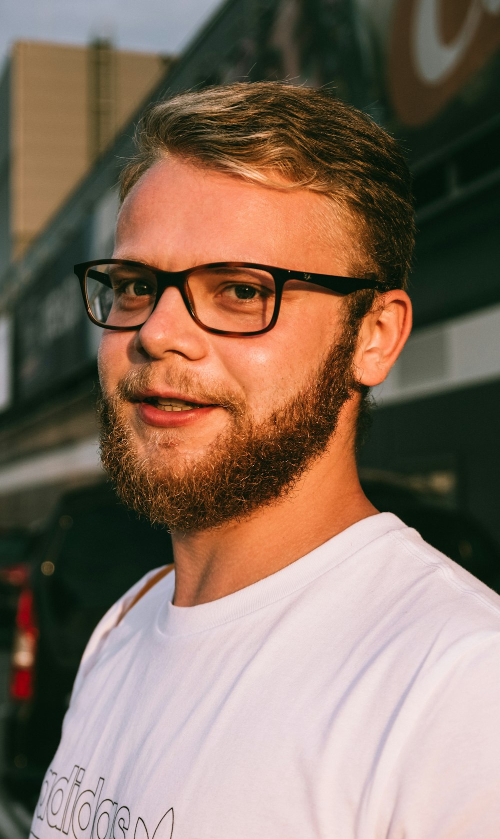 man in white crew neck shirt wearing black framed eyeglasses