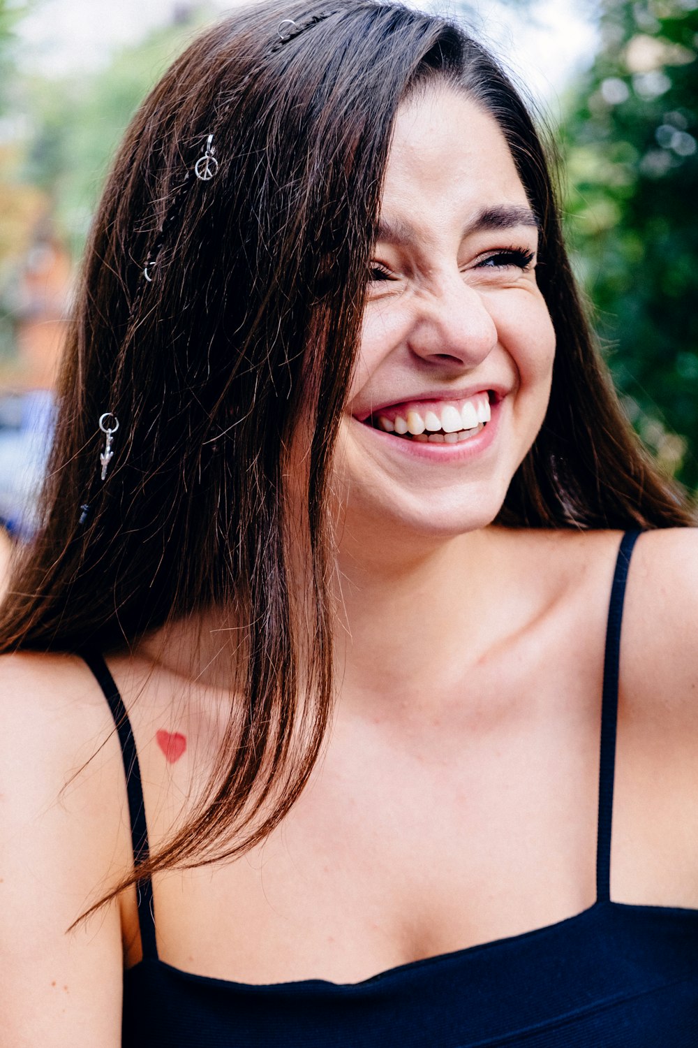 smiling woman in black spaghetti strap top