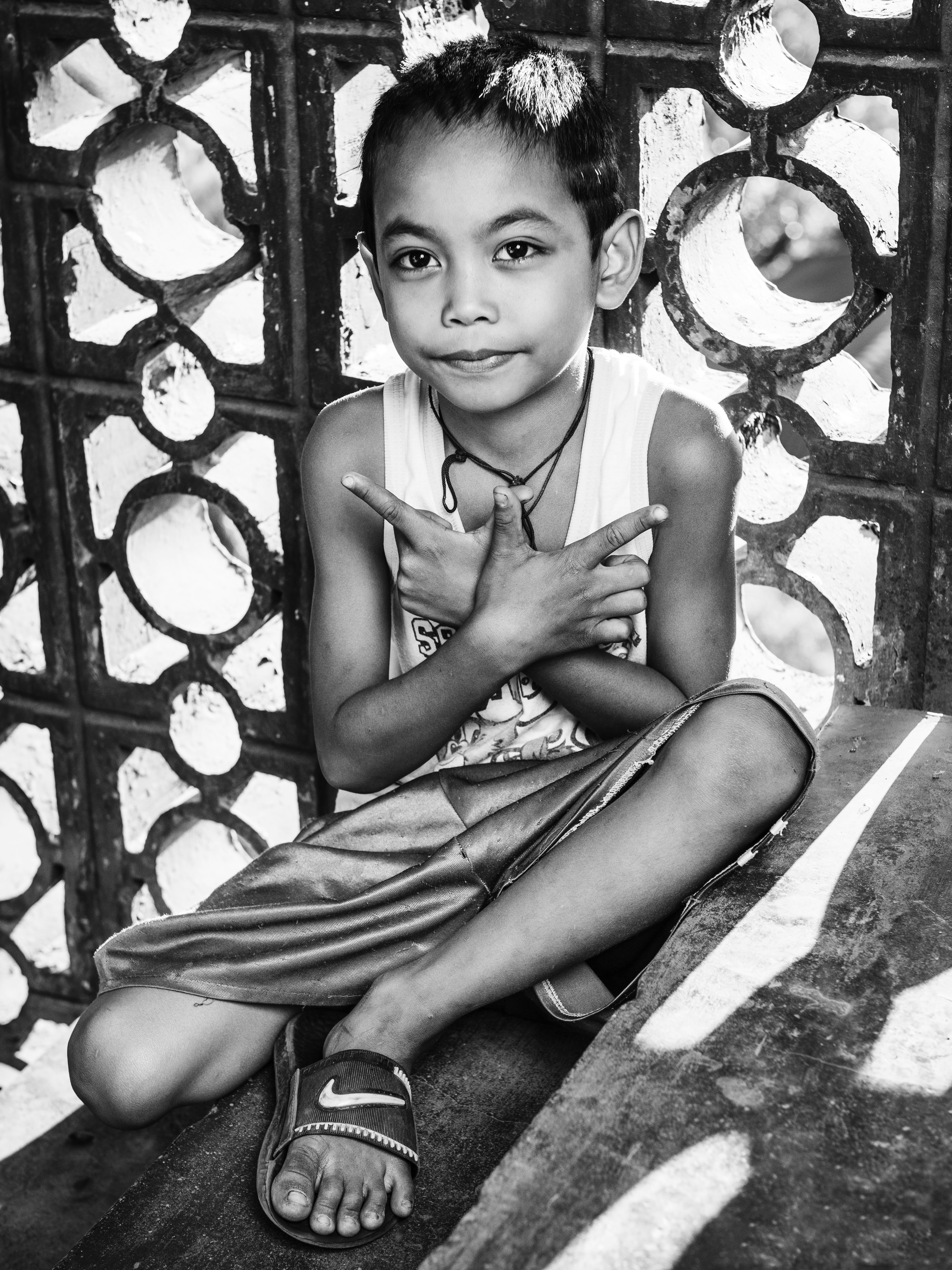 grayscale photo of girl in tank top and skirt sitting on floor
