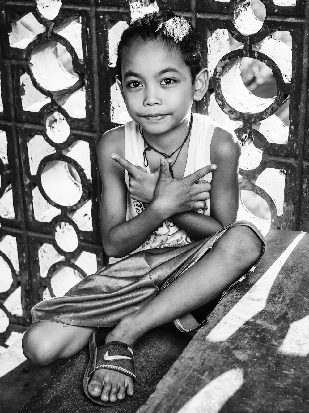 grayscale photo of girl in tank top and skirt sitting on floor