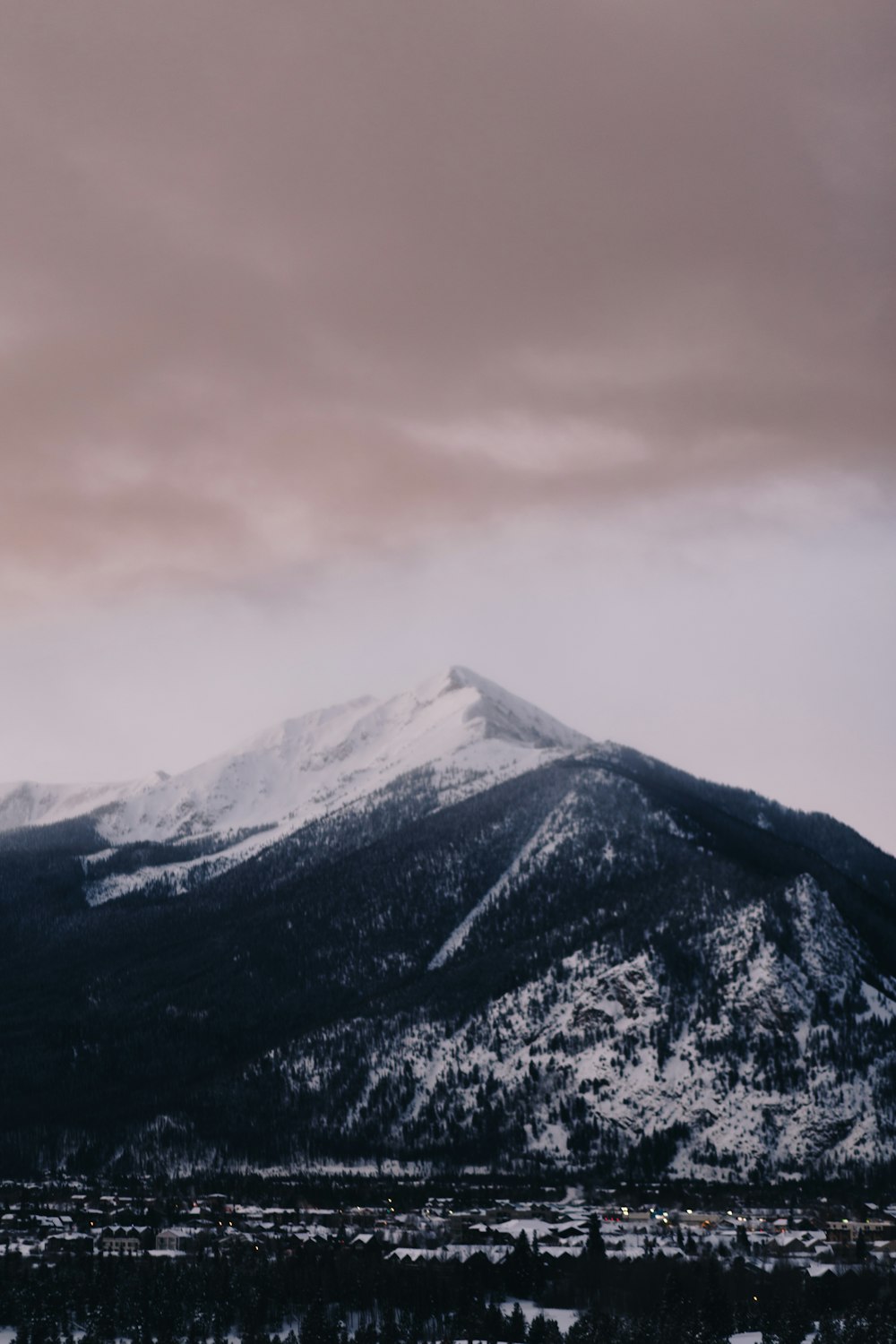 snow covered mountain under cloudy sky during daytime