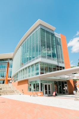 people walking on sidewalk near glass building during daytime