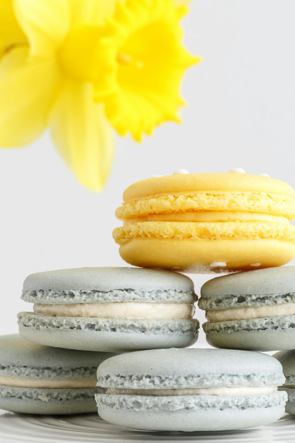 three yellow and white macaroons