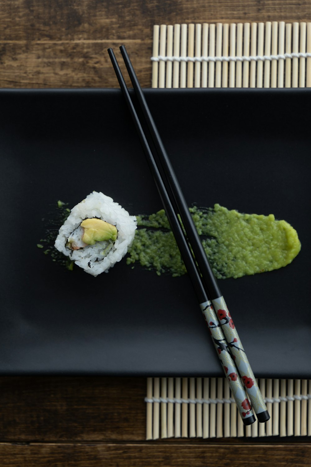 white and green sushi on black table