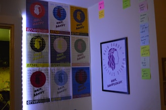 A wall covered with multiple colorful posters advertising 'Hair Bandy' along with a framed logo. The posters offer 10% off haircuts and have a prominent phone number. Sticky notes with handwritten reminders and tasks are arranged on the adjacent wall.