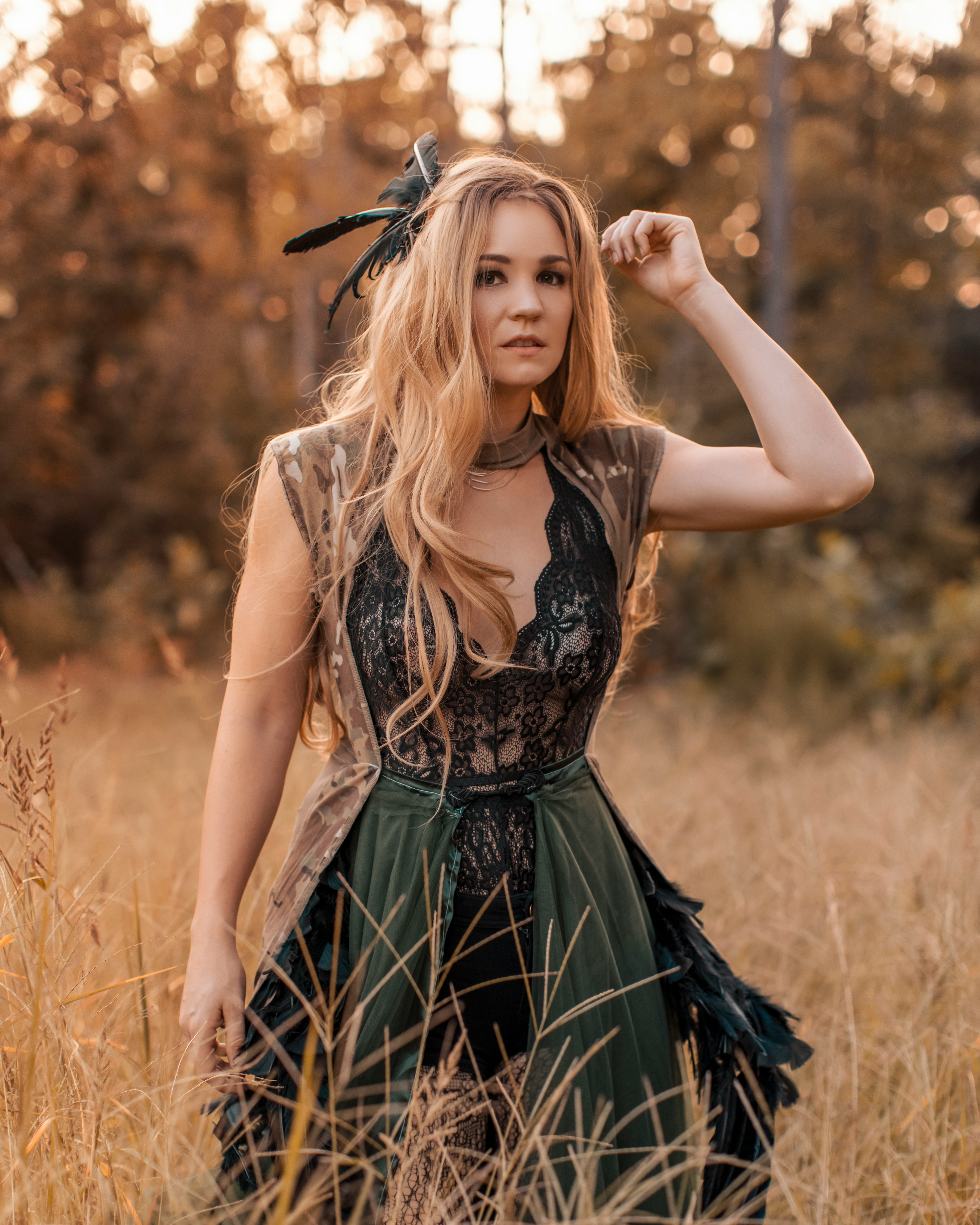 woman in black and white dress standing on brown grass field during daytime