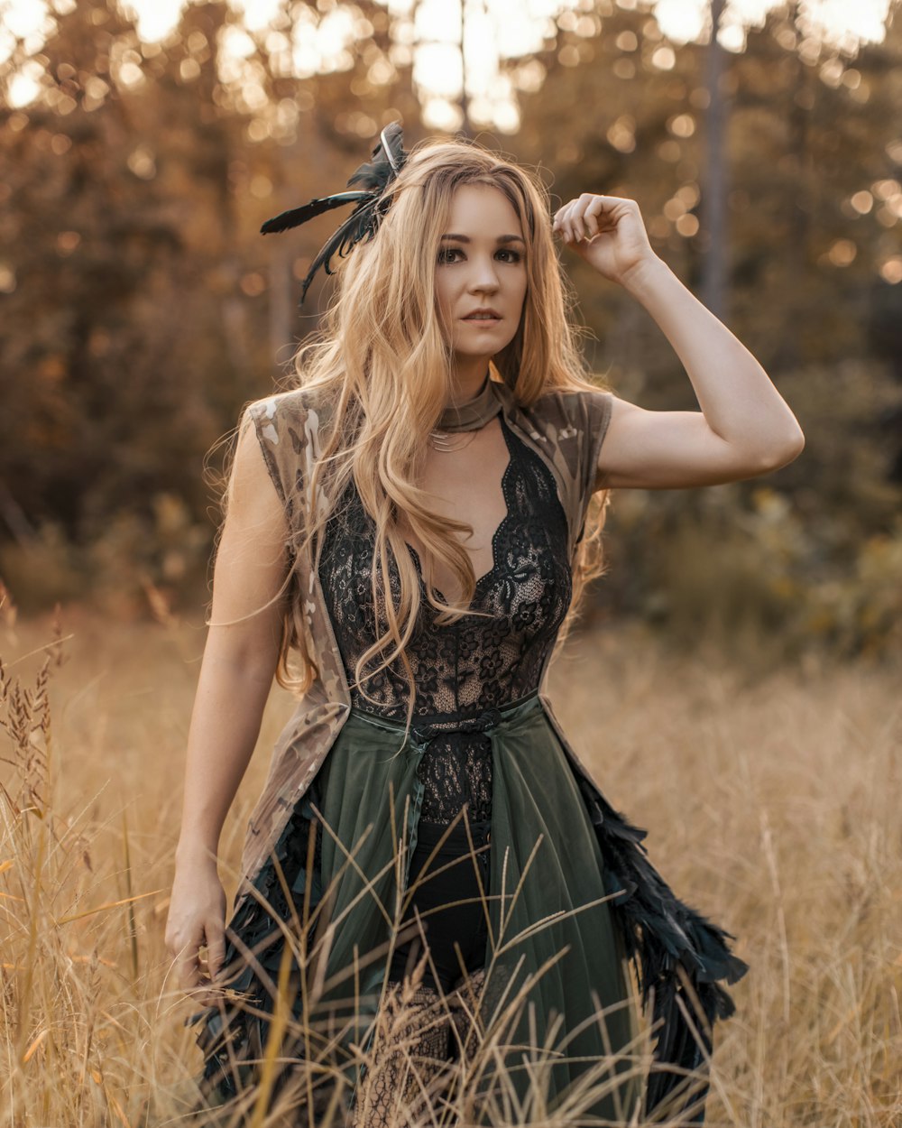 woman in black and white dress standing on brown grass field during daytime