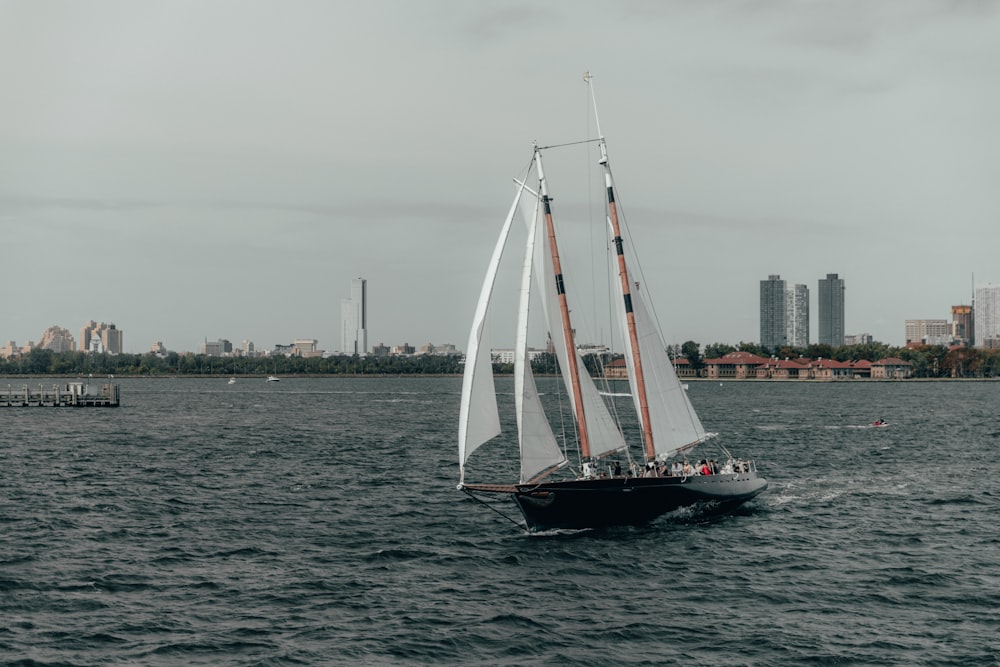 white sail boat on sea during daytime