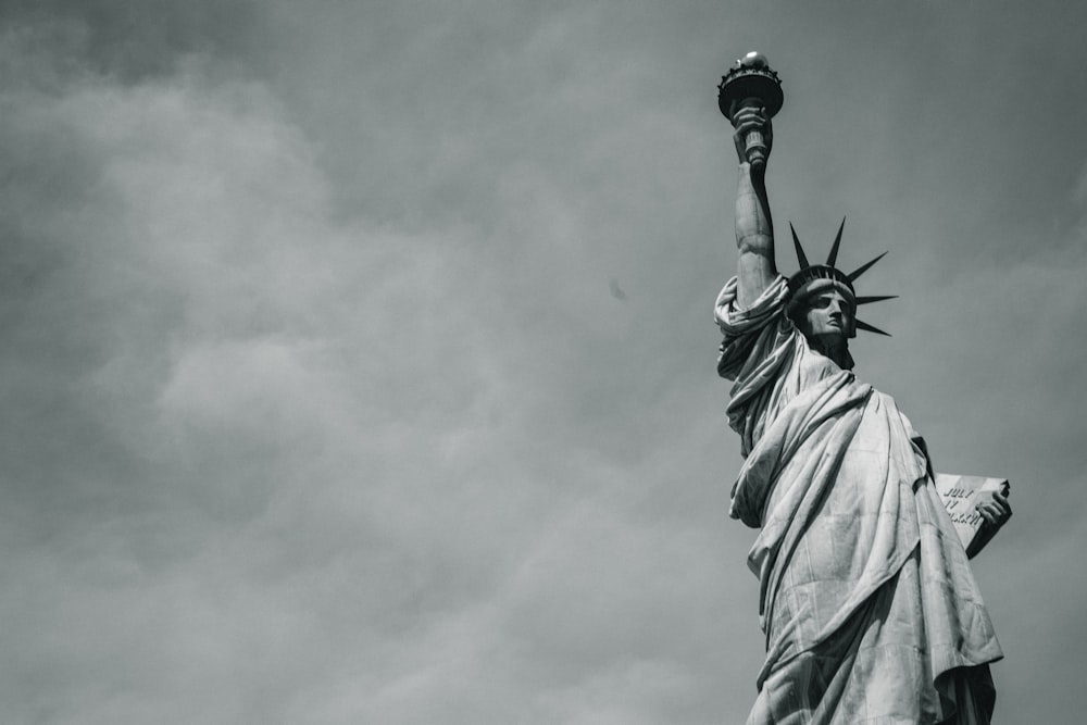 statue of liberty under cloudy sky during daytime