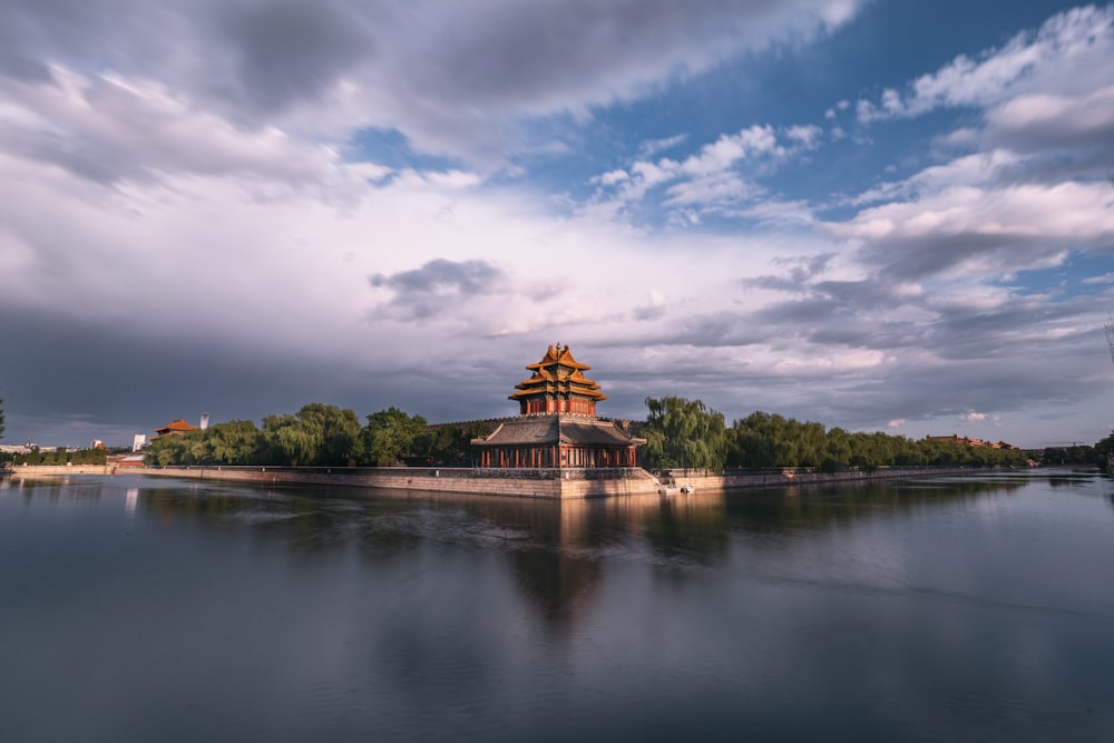 brown and beige building near body of water under blue sky