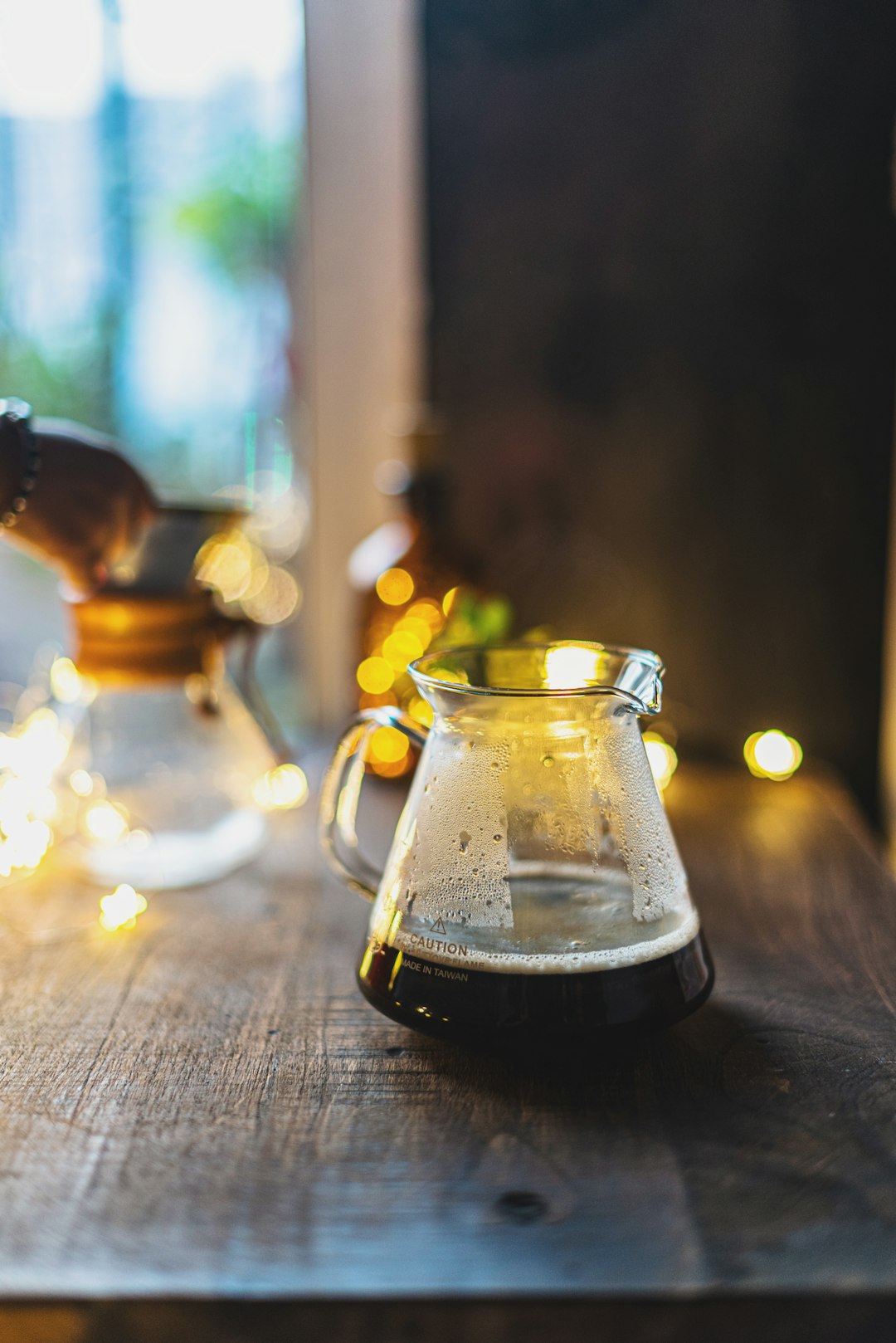 clear glass pitcher on brown wooden table