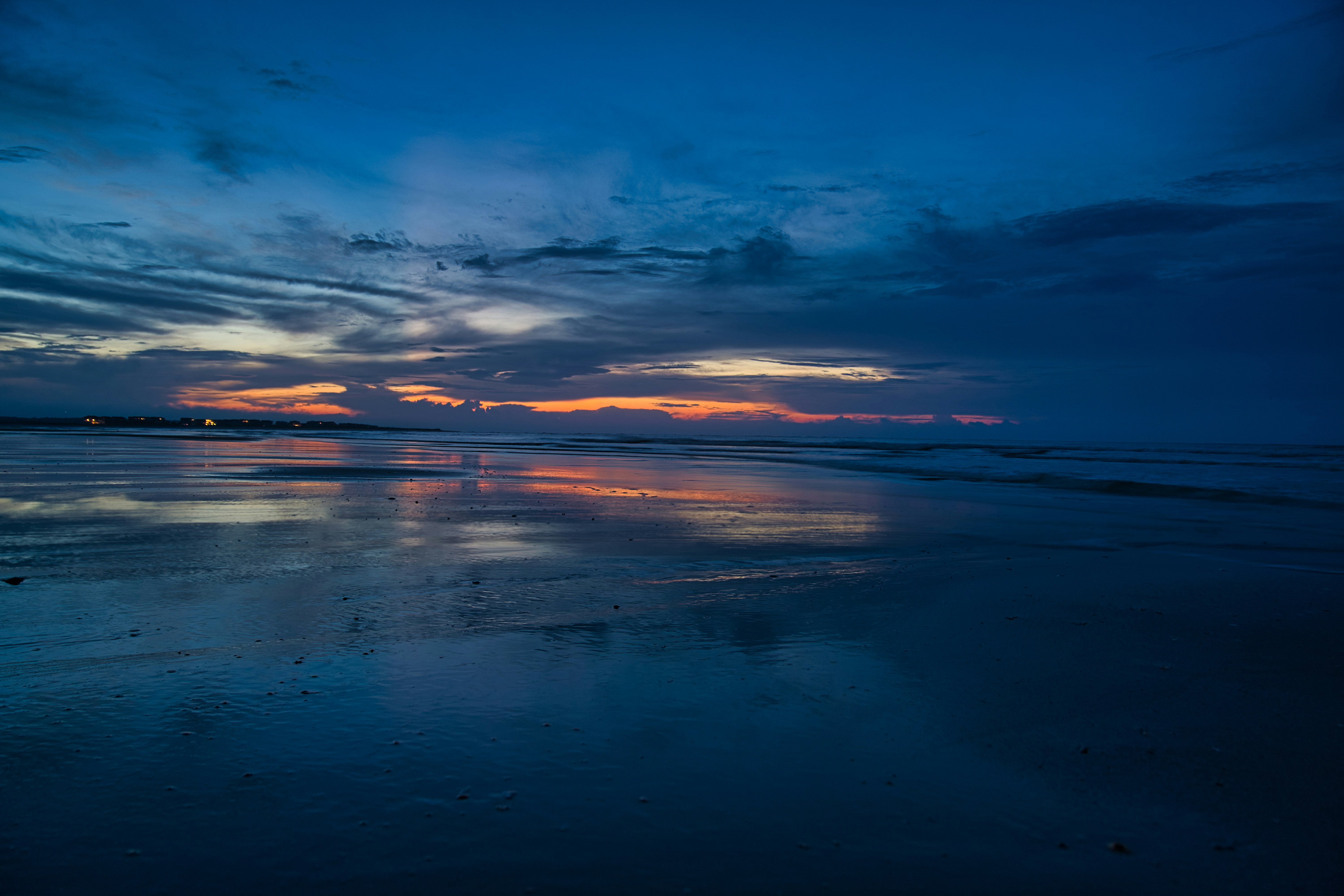 body of water under blue sky during sunset