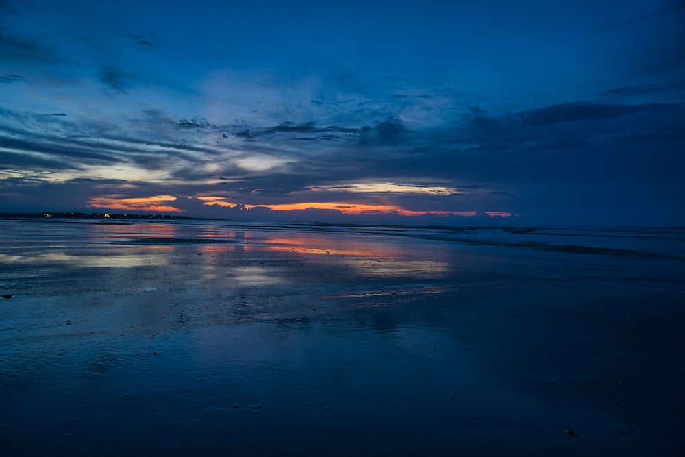 body of water under blue sky during sunset