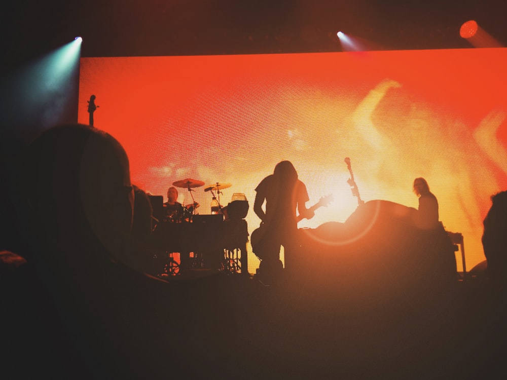 silhouette of people standing on stage