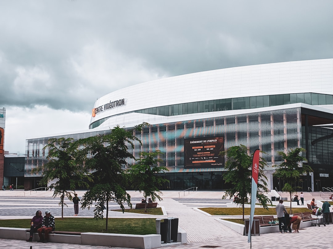 white concrete building with flags on top during daytime