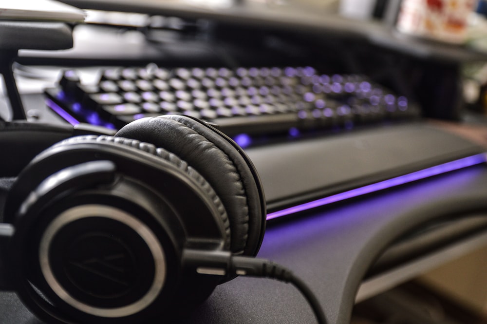 black and gray headphones on computer keyboard