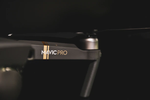 Close-up of a sleek drone frame made from matte carbon fiber filament.