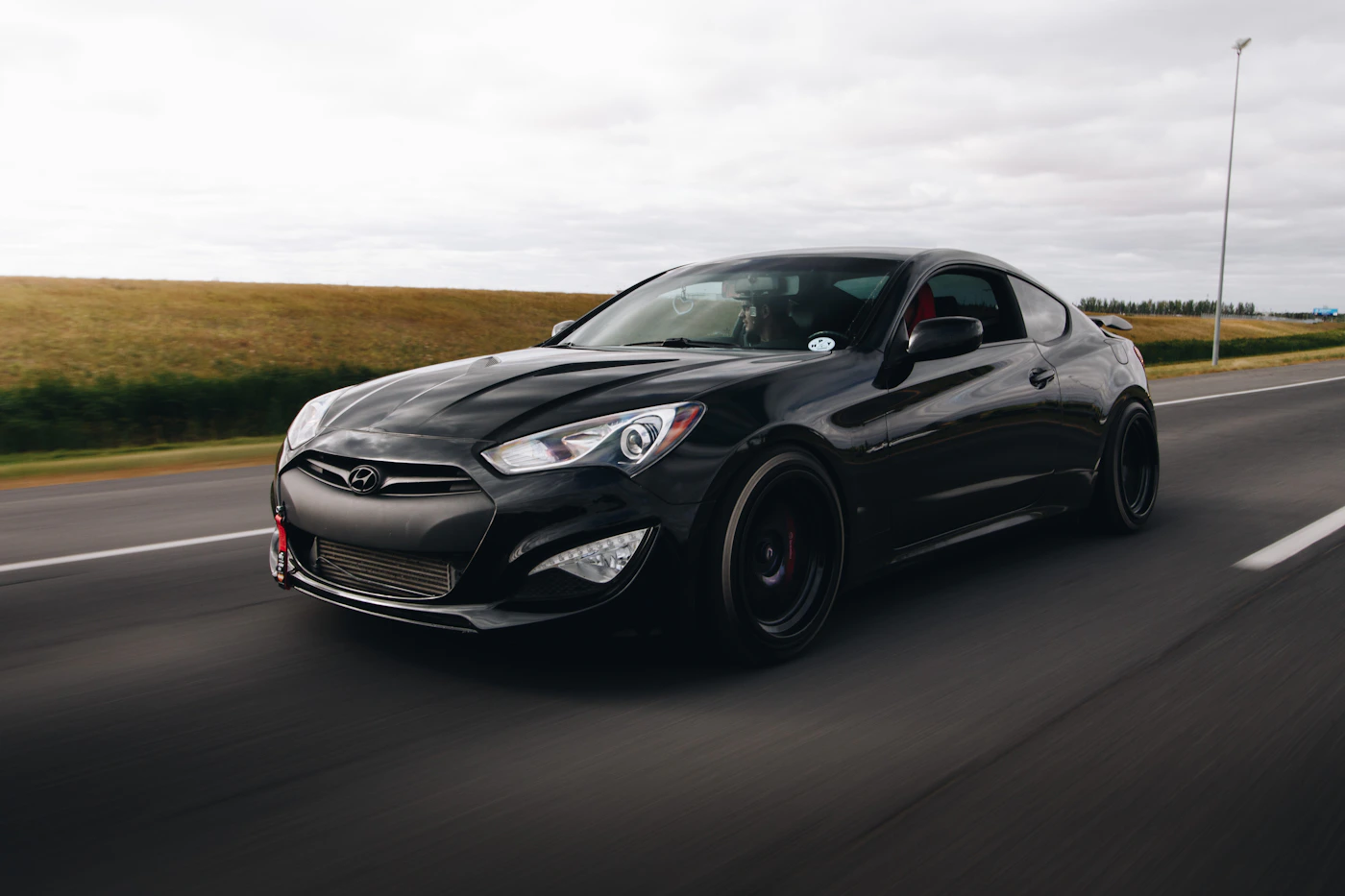 Black sports coupe on a road