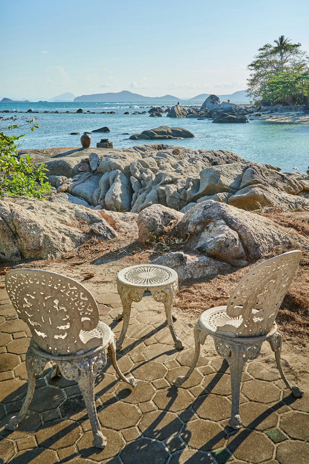 white round table on rocky shore during daytime