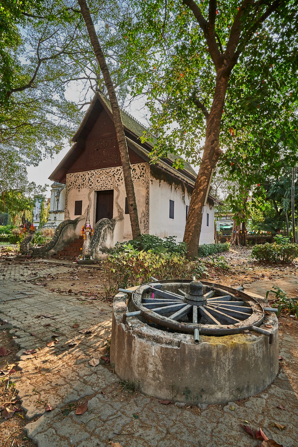 brown and white concrete house near green trees during daytime