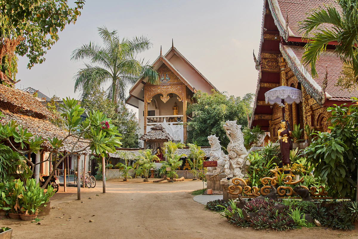 A leafy Chiang Mai temple courtyard with Lanna-style buildings