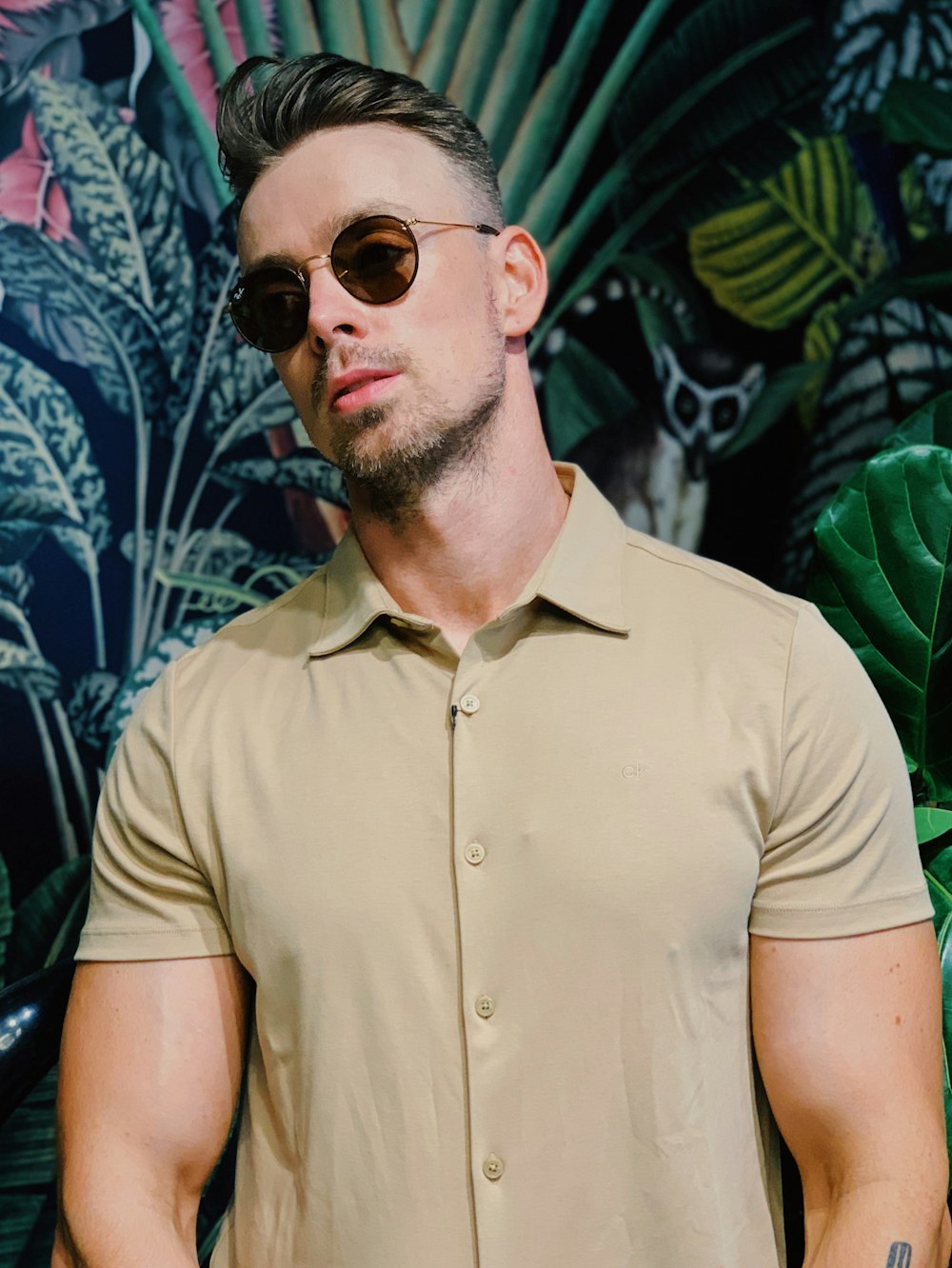 man in brown button up shirt wearing black sunglasses
