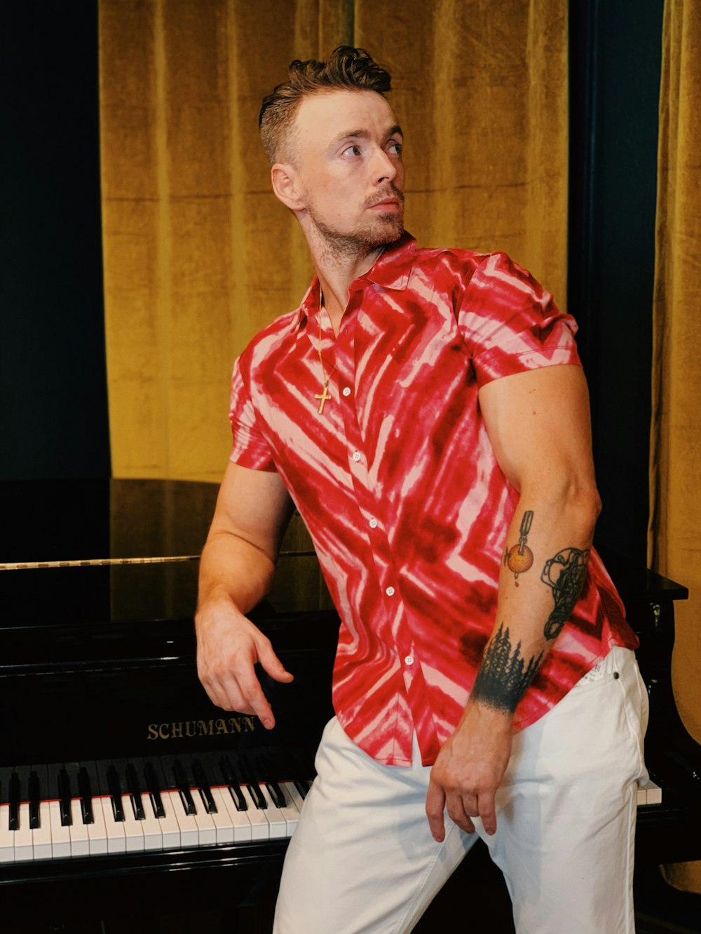man in red and white plaid button up shirt playing piano