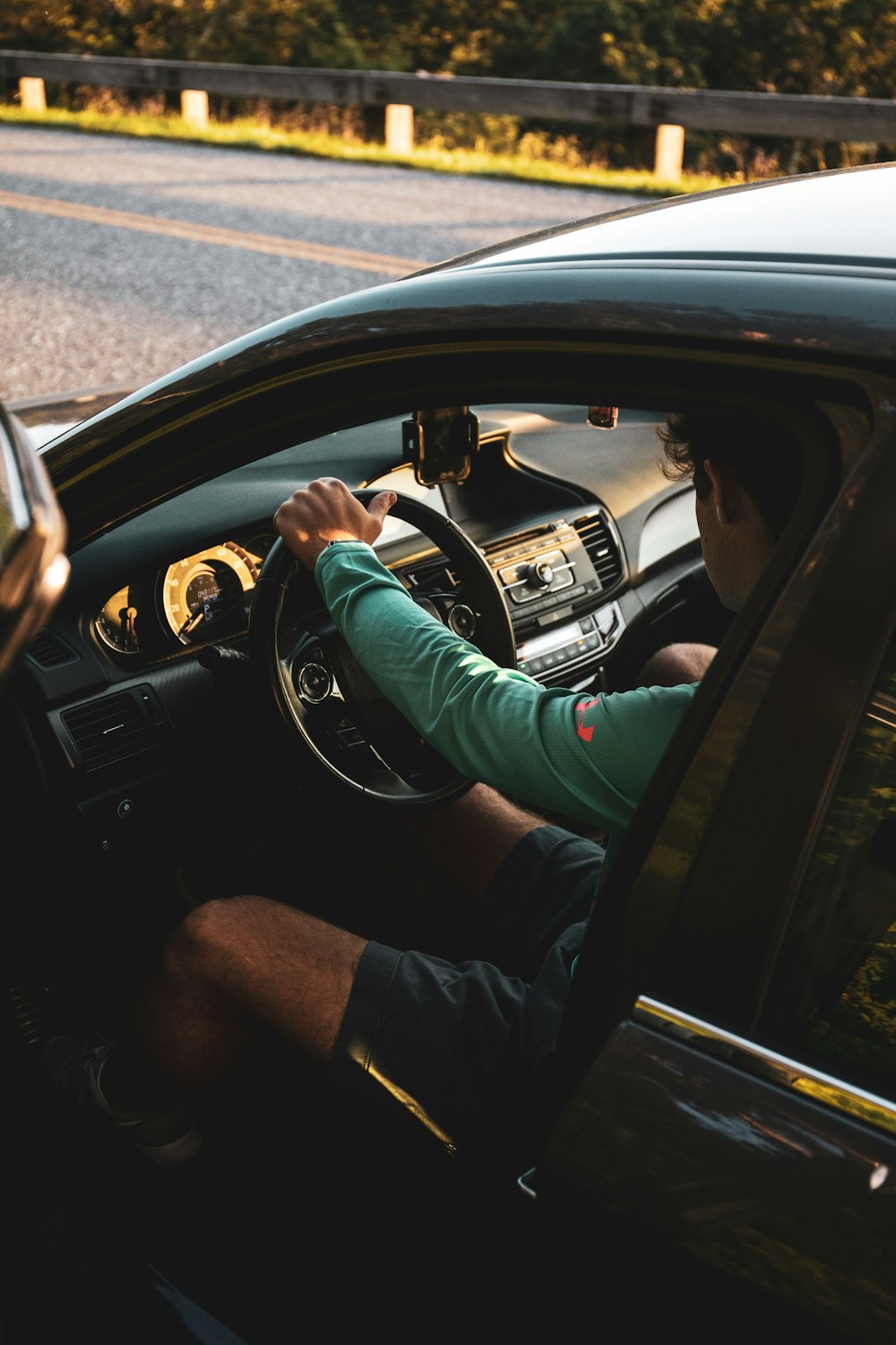 man in green long sleeve shirt driving car