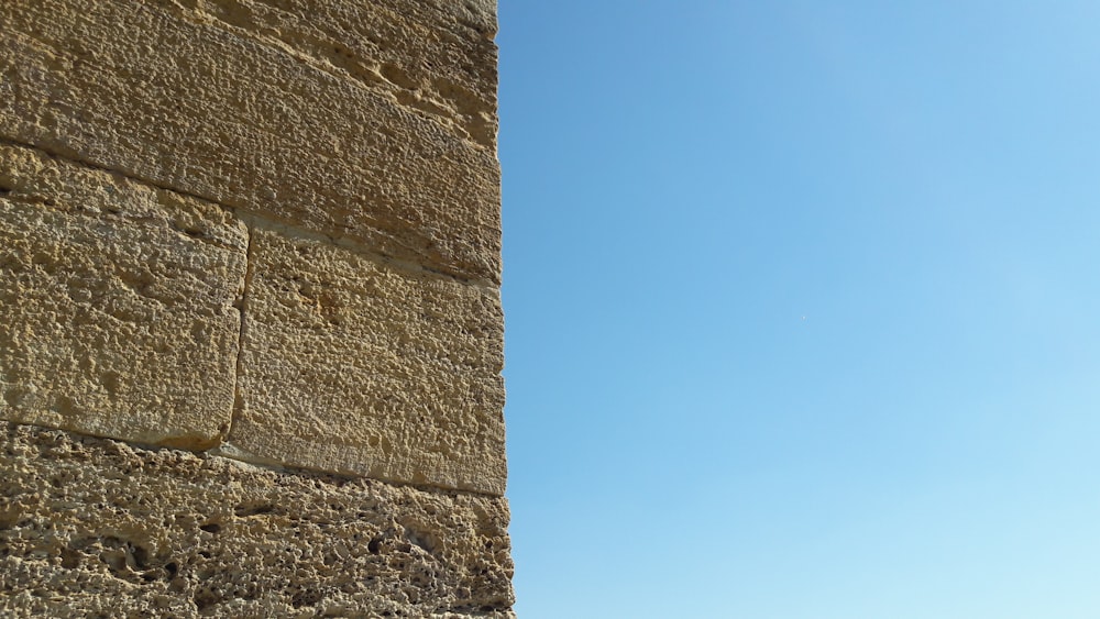 brown concrete wall under blue sky during daytime