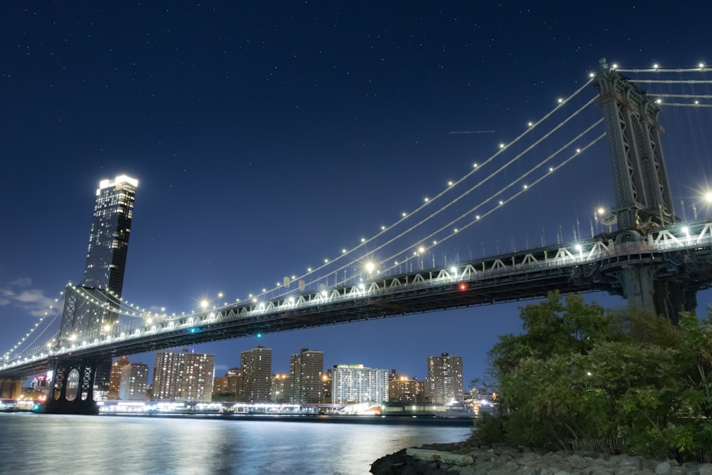 lighted bridge over river during night time