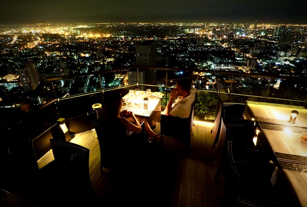 people sitting on chair near table during night time