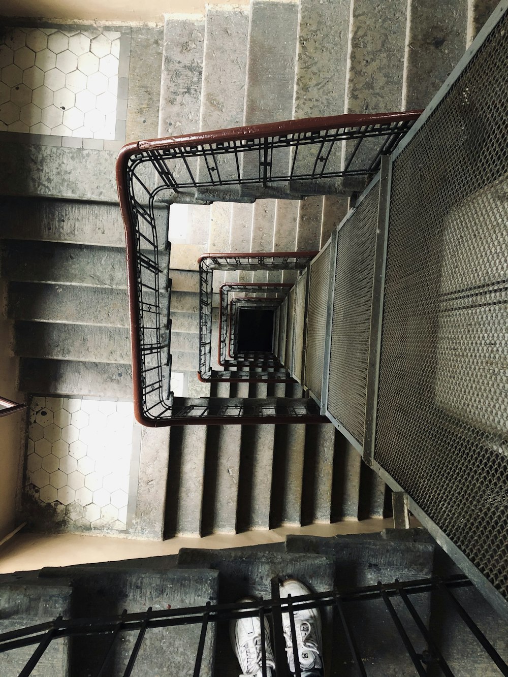 red metal railings on brown concrete stairs