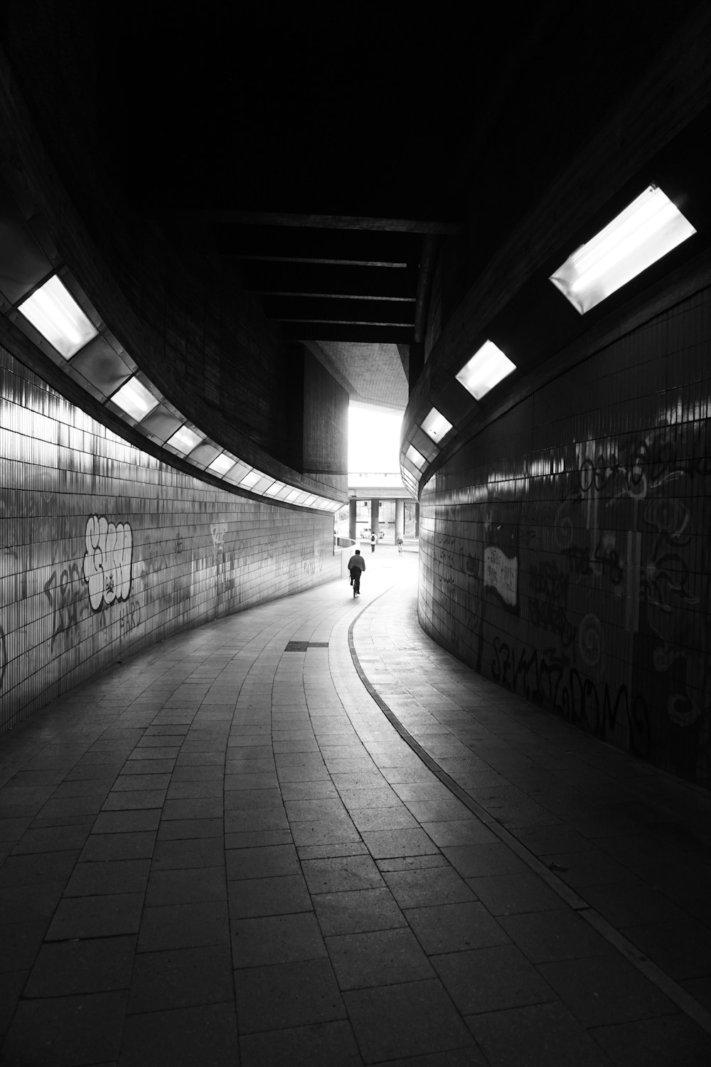 grayscale photo of people walking on hallway